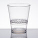 A clear plastic WNA Comet FunFusions rocks glass with a clear rim and patterned hole in the middle.