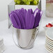 A bucket of Creative Converting amethyst purple plastic knives.