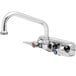 A T&S chrome wall mount faucet with two lever handles and an 8" swing spout.