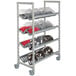 A Cambro Camshelving® Premium drying rack cart with plastic bins on it.