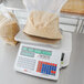 A Cardinal Detecto digital price computing scale with a bag of noodles on it.