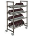 A Cambro Elements angled drying rack with plates on it.