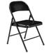 A black National Public Seating metal folding chair.