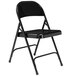 A black National Public Seating metal folding chair with a folding frame on a white background.