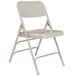 A gray National Public Seating folding chair with a white background.