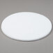 A white round Scrubble by ACS Type 41 27" floor pad on a gray surface.