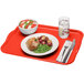 A red Cambro rectangular tray with food on it and a fork on a table.