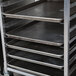 An unassembled Channel half height sheet pan rack with trays on it.