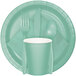 A green disposable plate with a Fresh Mint Green Creative Converting cup, spoon, fork, and napkin.