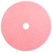 A pink circular Scrubble burnishing pad with a hole in the middle.