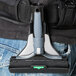 A person wearing jeans with a black and grey Unger ErgoTec Ninja glass scraper holster on their back.