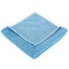 A blue Unger SmartColor microfiber towel folded on a white background.