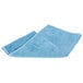 A blue Unger SmartColor Microfiber cleaning cloth folded on a white background.