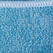 A close up of a blue Unger SmartColor microfiber cleaning cloth with white trim.