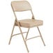 A beige National Public Seating steel folding chair with a beige vinyl padded seat and back.