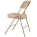 A National Public Seating beige steel folding chair with beige vinyl padding.