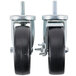 A pair of Master-Bilt stem casters with black rubber wheels and nuts on the stems.