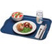 A blue Cambro rectangular fiberglass tray with food, a fork, and a knife on it.