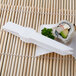 Fineline white plastic tongs serving a sushi roll.