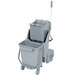 A white and grey Unger floor cleaning cart with two baskets.