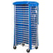 A blue and silver rolling cart with a blue plastic cover.
