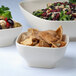 A group of Thunder Group Passion Pearl square melamine bowls filled with food on a white table.