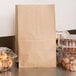 A Duro brown paper bag on a counter filled with pastries.