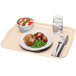 A white rectangular Cambro fiberglass tray with food and a glass of water on it.