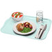 A sky blue Cambro rectangular fiberglass tray with food, a fork, and a knife on it.