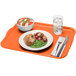 A rectangular orange Cambro cafeteria tray with food on it.