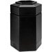 A black hexagonal waste container with an open top.