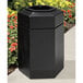 A black hexagonal Commercial Zone trash can with an open top.