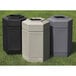 Three black hexagonal waste containers with open tops sitting on the grass.