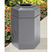 A grey hexagonal waste container with an open top.