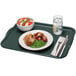 A Cambro rectangular slate blue fiberglass tray with food and a fork on it.