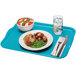 A Cambro rectangular blue fiberglass tray with a plate of food and a fork on it.