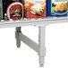 A Cambro Camshelving dunnage stand with cans of food on it.