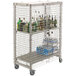 A wire security cage on a Cambro mobile shelving unit filled with bottles of alcohol.