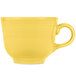 A yellow tea cup with a handle.