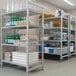 A Cambro Camshelving® mobile unit with solid shelves holding bottles and containers.