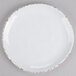 A white round melamine plate with irregular edges and gold speckled trim.