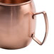A close-up of a Clipper Mill brushed copper Moscow Mule mug with a handle.