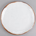 A white GET Rustic Mill melamine plate with brown speckled edges.
