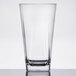A clear GET SAN plastic beverage glass with a reflection.