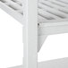 A white plastic Cambro Camshelving unit with vented and solid shelves.