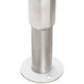 A metal pole with a silver cylinder on a round base.