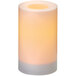 A Sterno white flameless pillar candle with a yellow light inside.