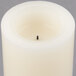 A white Sterno programmable flameless wax pillar candle with a black needle.