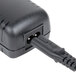 A black power cord plugged into a black box with a USB plug.