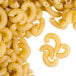 A pile of Regal elbow macaroni pasta on a white background.